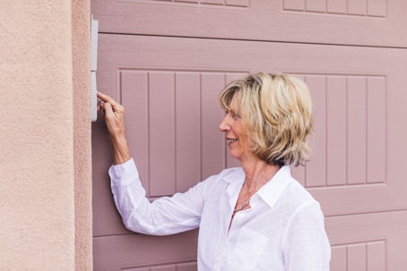 A woman controlling the garage door control