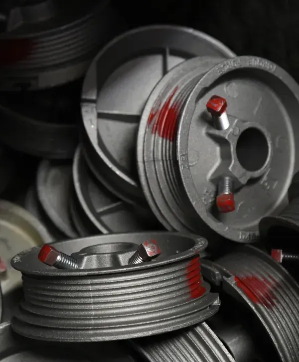 Close-up of metal garage door hardware parts and components stacked together.