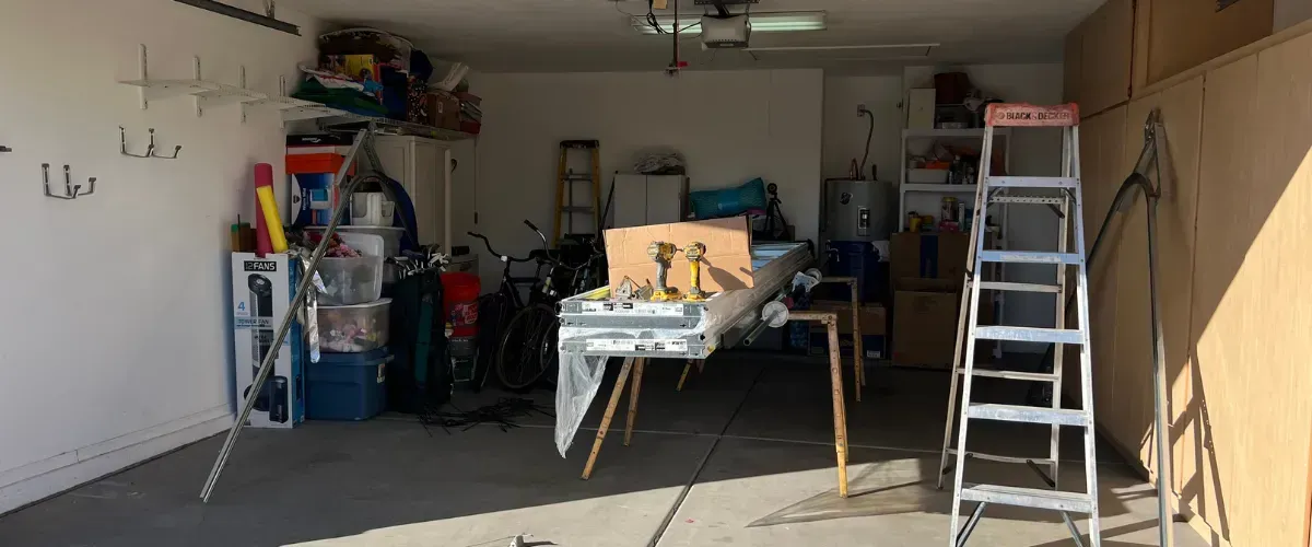Interior view of garage with tools and new door panels ready for installation