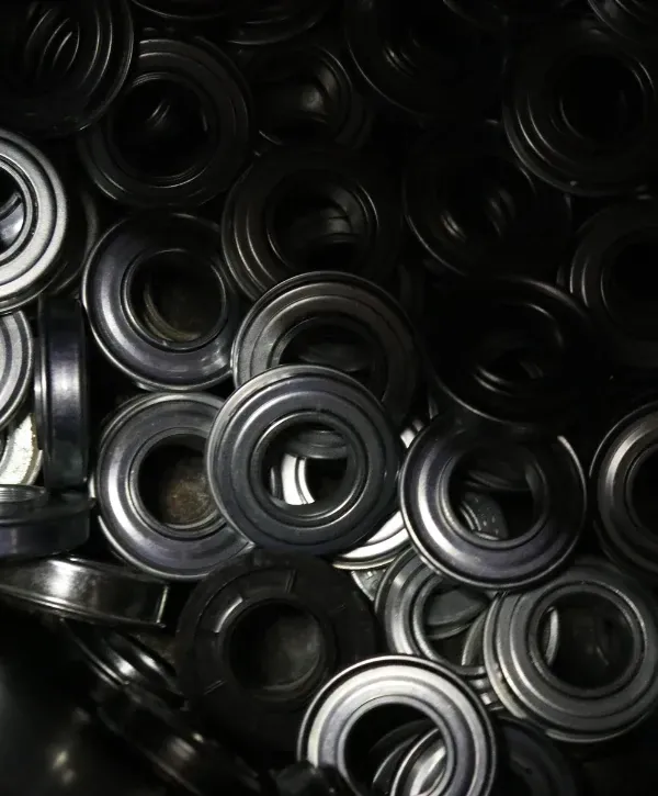 Pile of black garage door rollers used for replacement and maintenance.