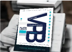 A book titled 'Venture Philanthropy Blueprint' held in someone's hands