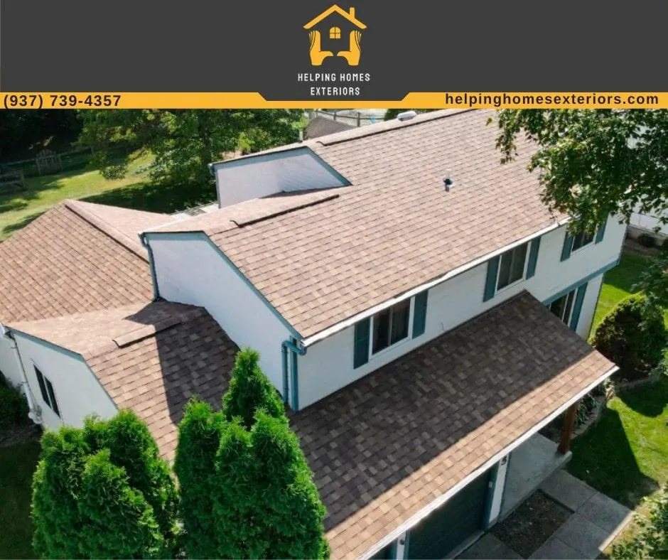 a house with shingle roofing and white siding