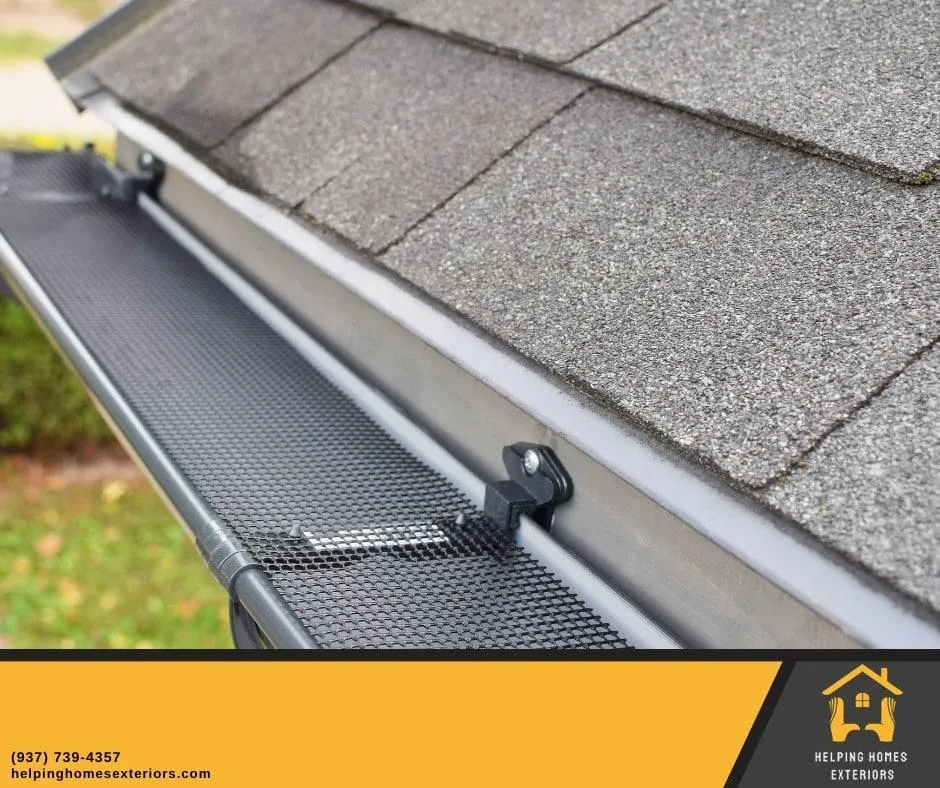 a gutter of a house with shingle roof