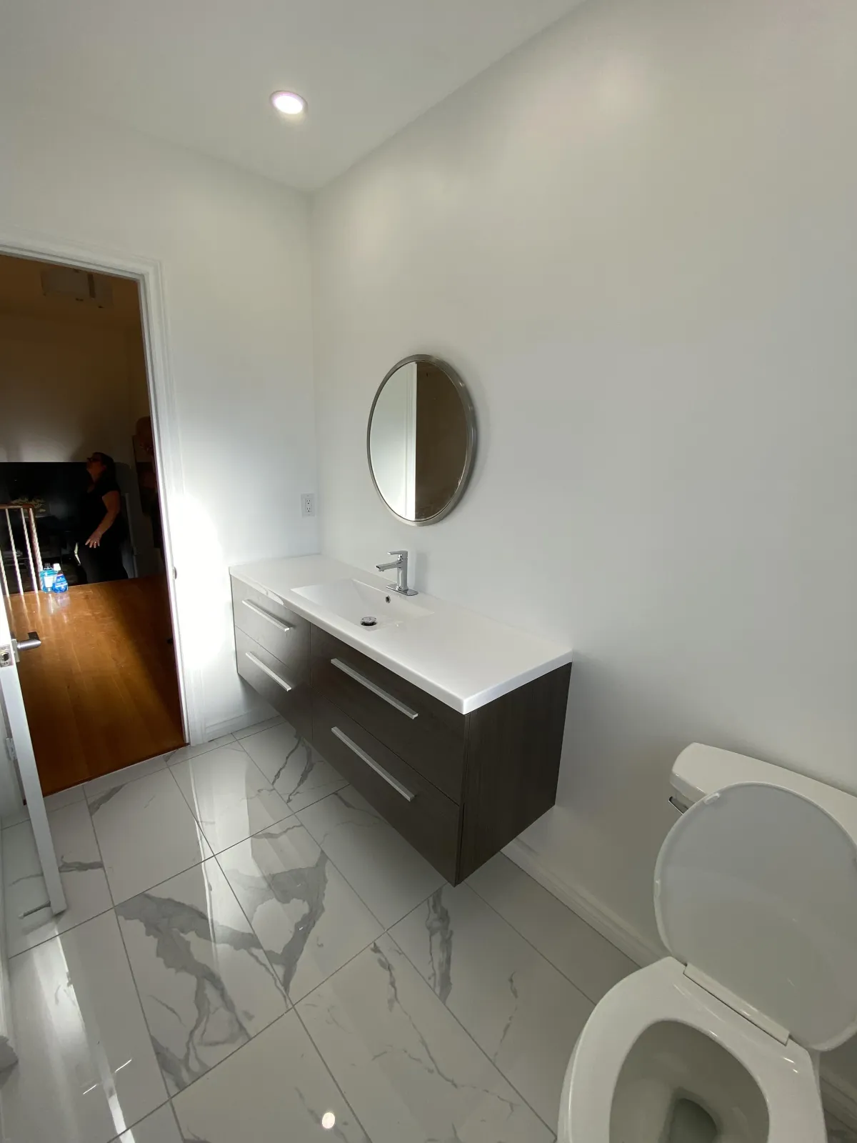 Small bathroom remodel in a Toronto condo with space-saving fixtures and bright lighting.