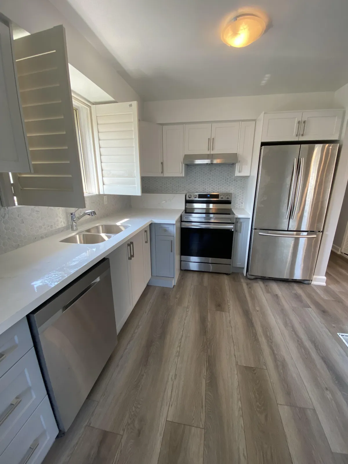 A Toronto kitchen remodeling project with an expanded cooking space and upgraded lighting.