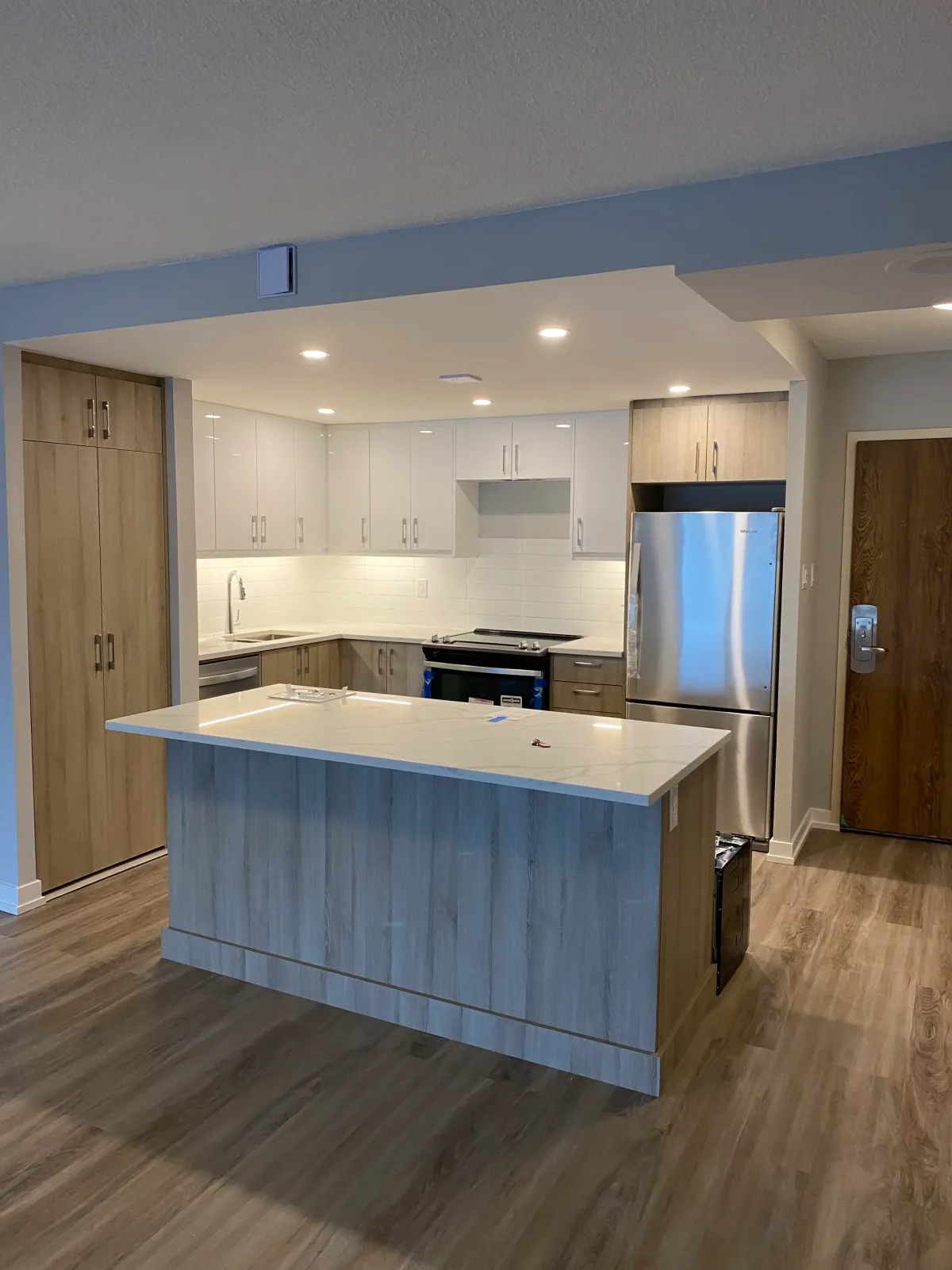 Kitchen contractors in Toronto installing custom cabinetry and new appliances.