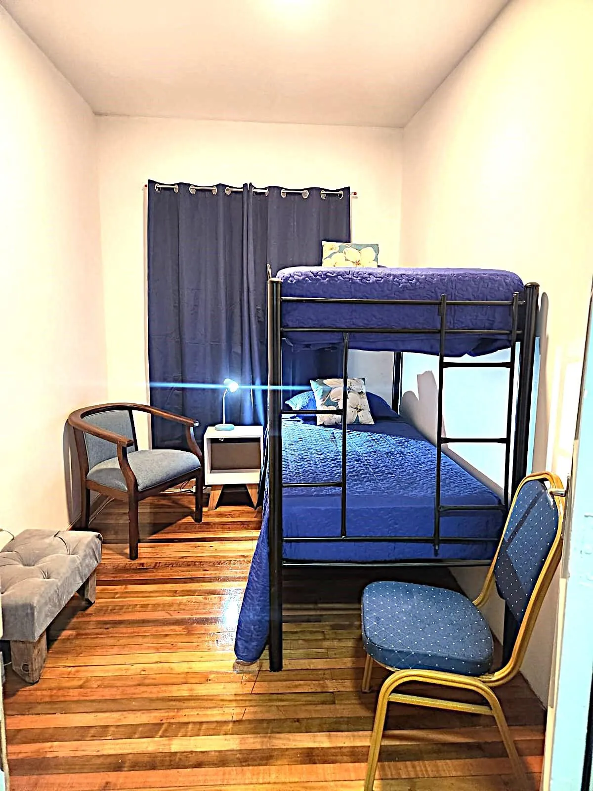 a bedroom with a large bed and a large mirror