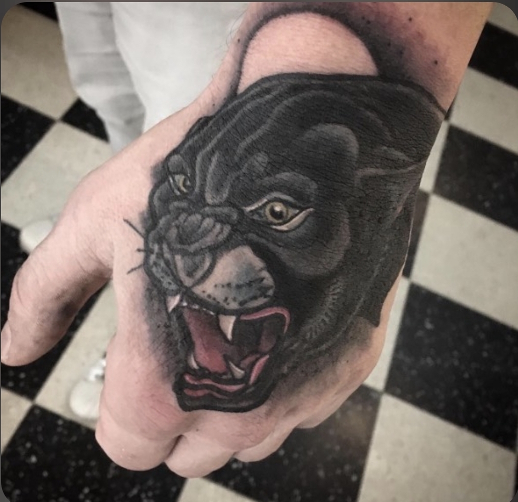 person in blue denim shorts and white nike sneakers standing on gray concrete floor