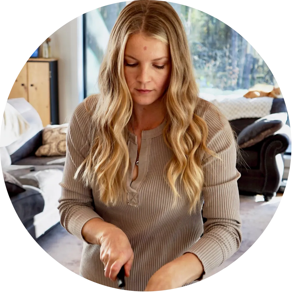 woman looking down cutting bread