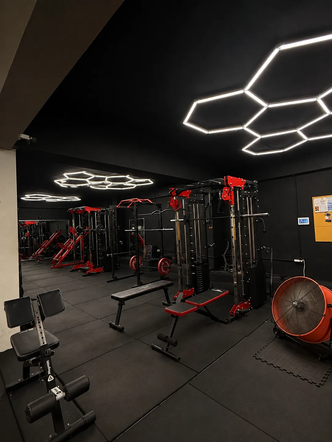 Chalked hands gripping a heavy barbell in a dark noir gym setting