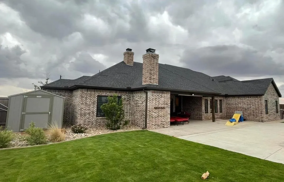 Professional gutter installation on a residential home in Lubbock, Texas, showcasing skilled technicians at work