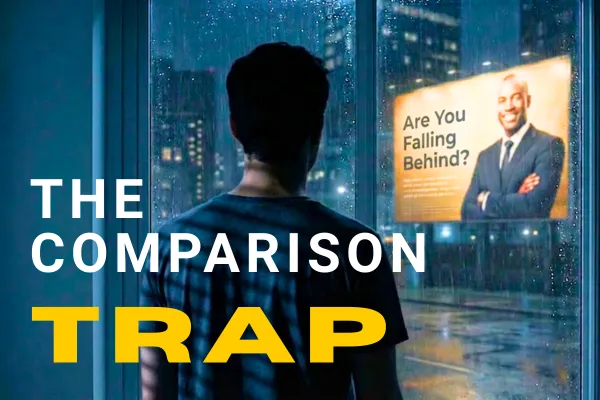 Silhouette of young man looking out the window at a billboard of a successful business person with the caption "The Comparison Trap"