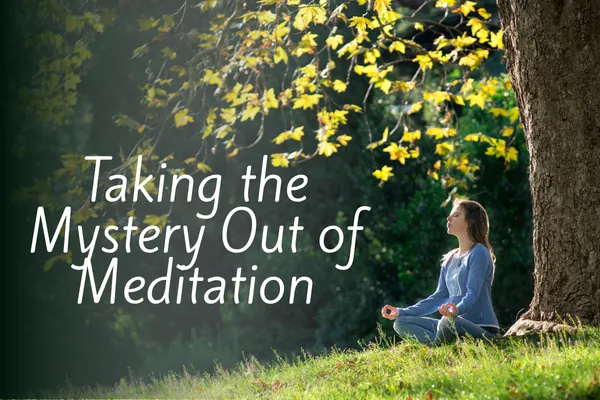 Young woman sitting outside under a tree, meditating with the caption "Taking the Mystery Out of Meditation".
