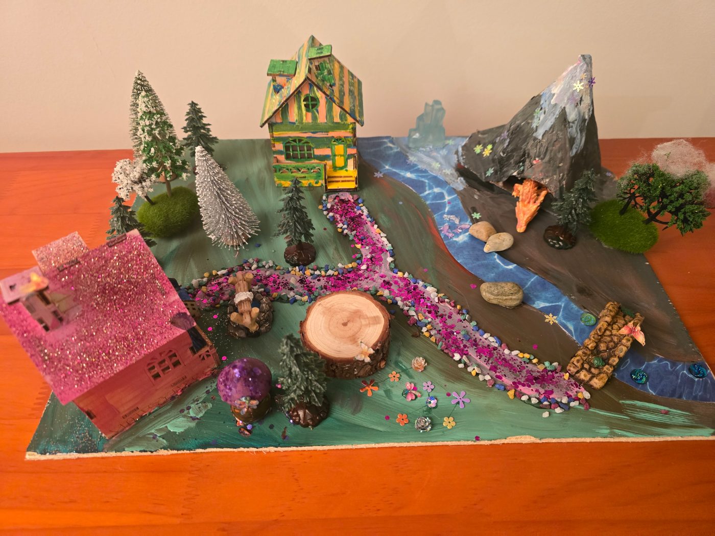 A dragon landscape with a river and a volcano, made by a child