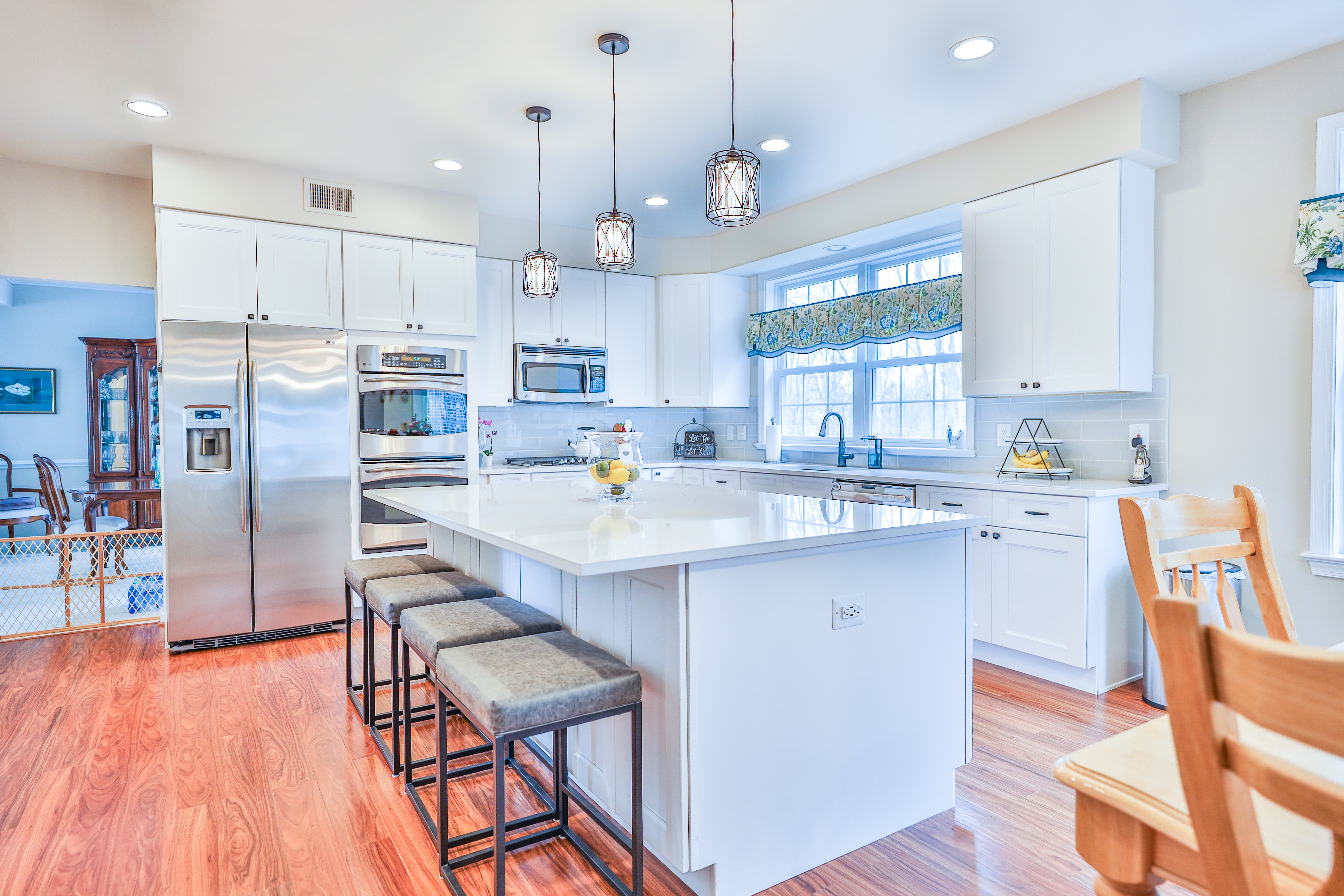 Sleek white kitchen cabinets with built-in appliances in Chevy Chase MD