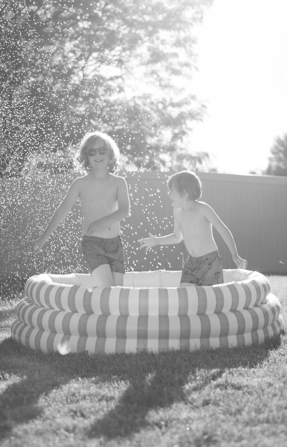 children-playing-in-pool-with-hose