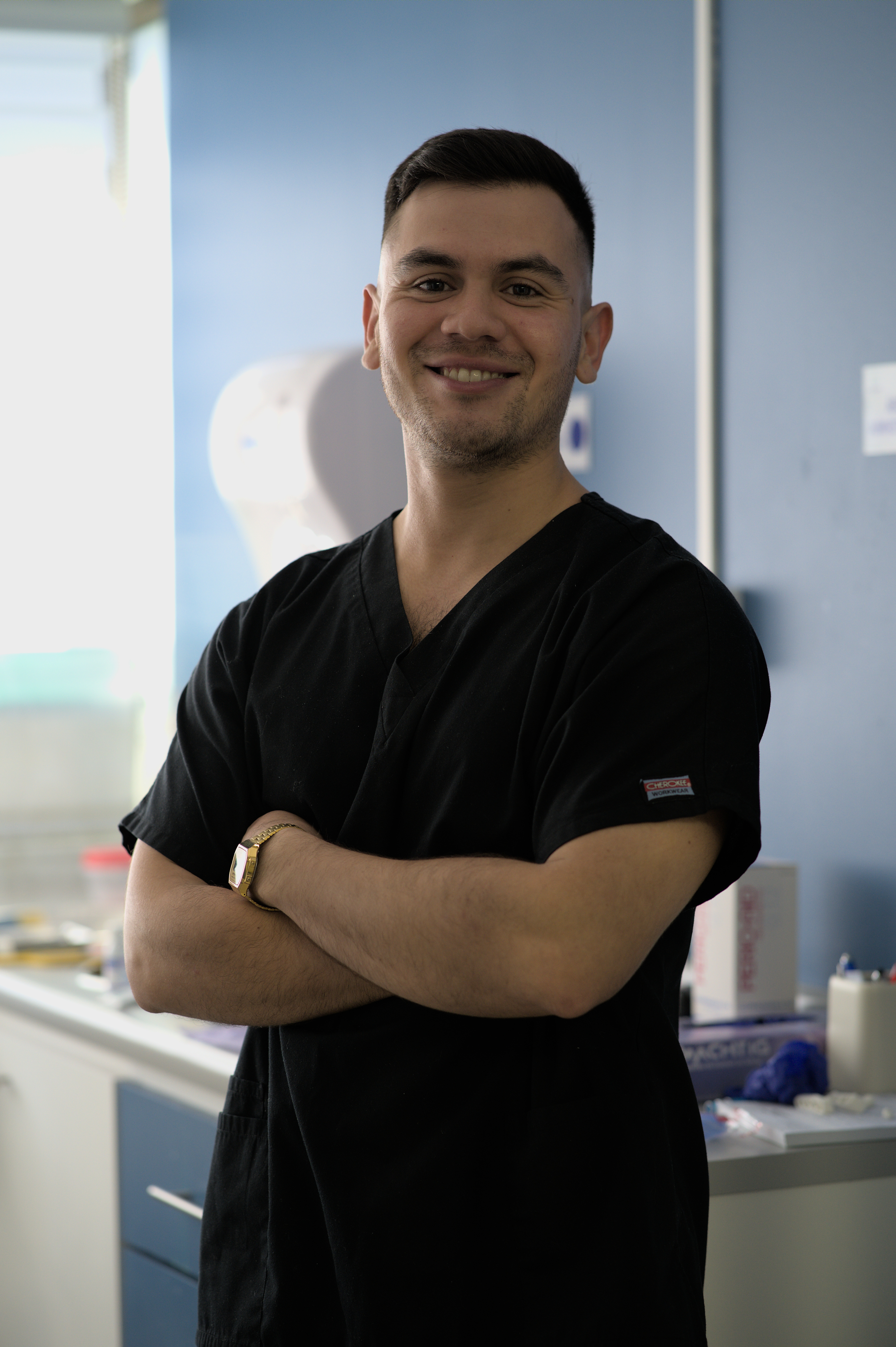 Medical professionals practice a dental procedure on a mannequin.
