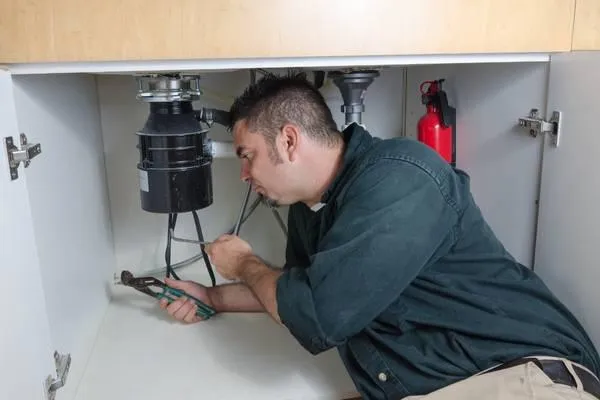 Garbage disposal repair technician