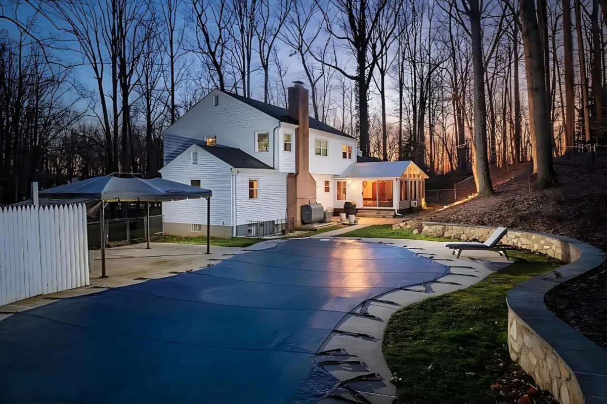 green trees near white 2-story house