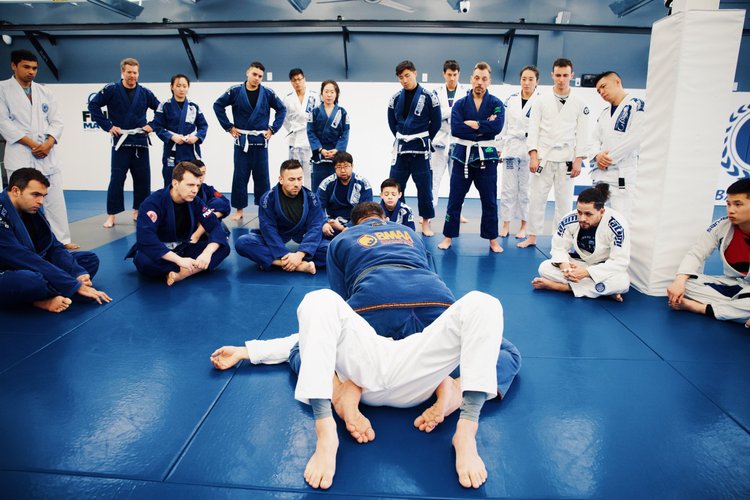 girl and boy doing Brazilian jiu-jitsu