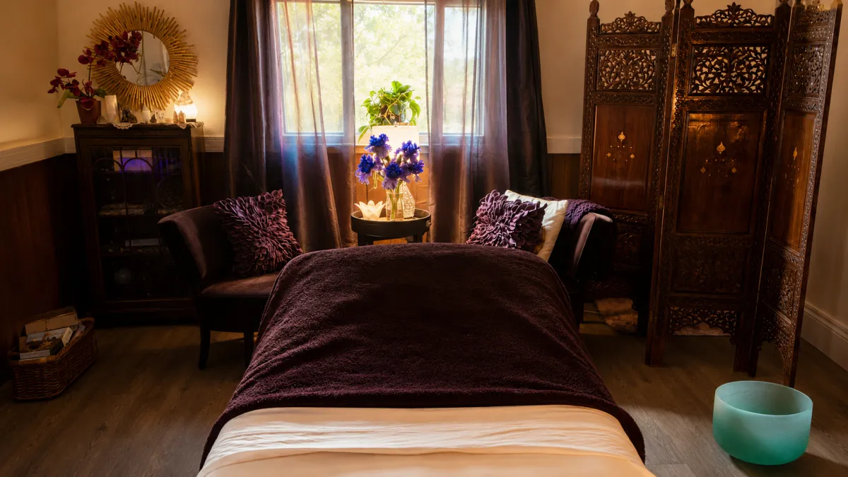 Warm and inviting Daysdream treatment room in Armstrong, BC, featuring a purple facial treatment bed