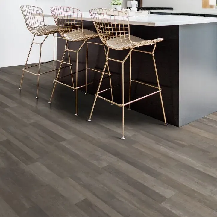 Stylish kitchen with dark vinyl flooring and gold bar stools at a modern island
