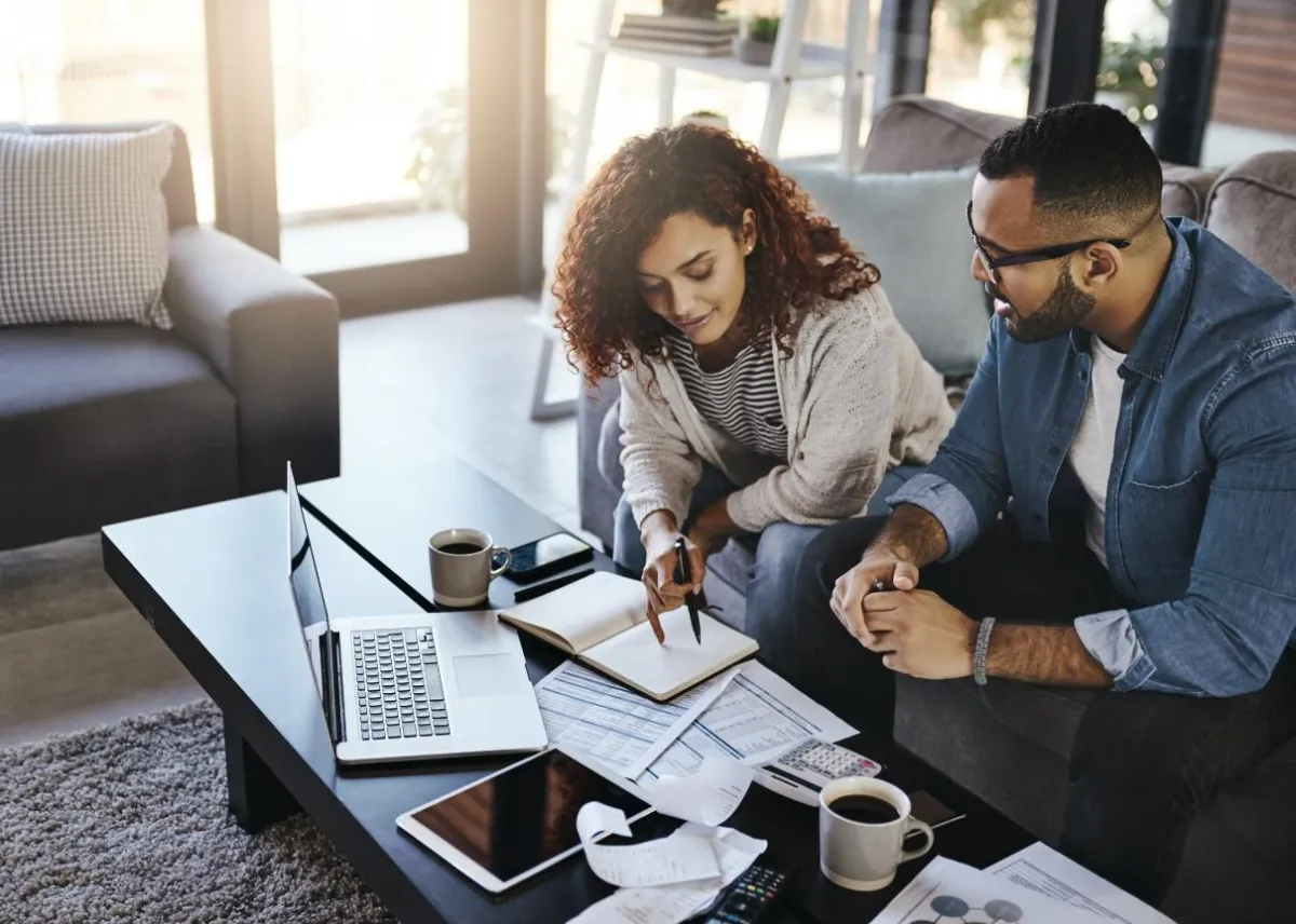 woman in black jacket holding white paper