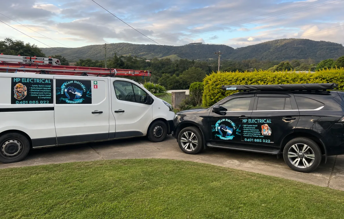 HP Electrical van and vehicle parked at a Moreton Bay job with hills in the background