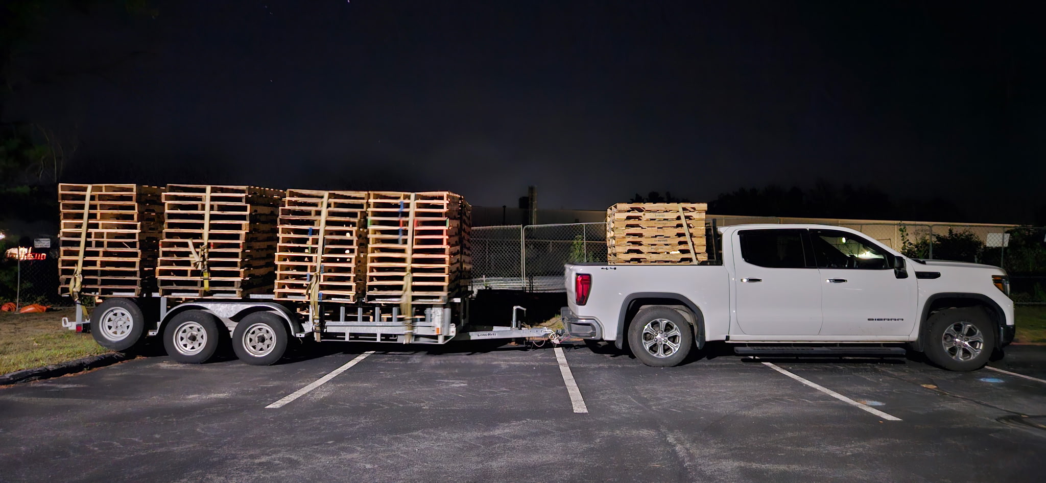 Stacks of used wooden pallets at a small family pallet yard