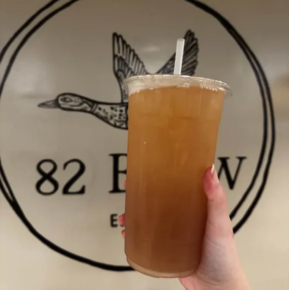 Iced orange colored specialty drink served at 82 Brew coffee shop
