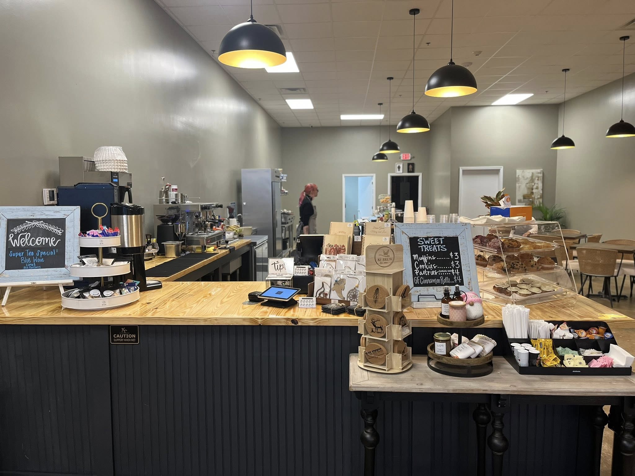 Inside counter view of 82 Brew coffee shop with pastries and drink station in Dawson Georgia