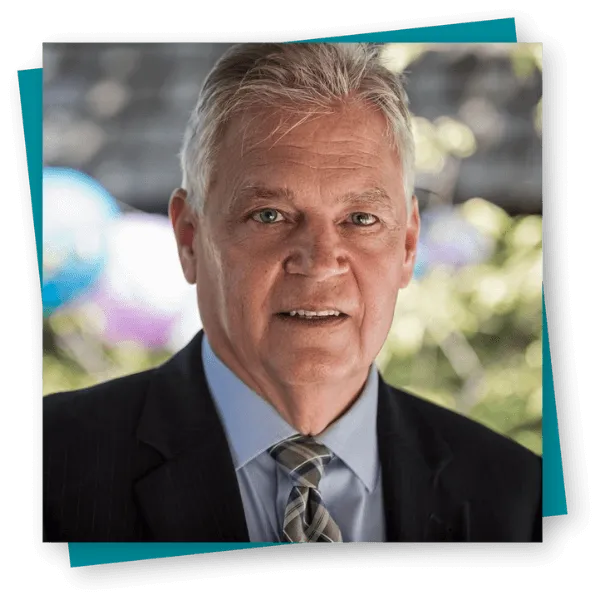 Paul Reitz, Broker/Owner of EXIT Realty Elite, in a professional headshot wearing a suit and tie.