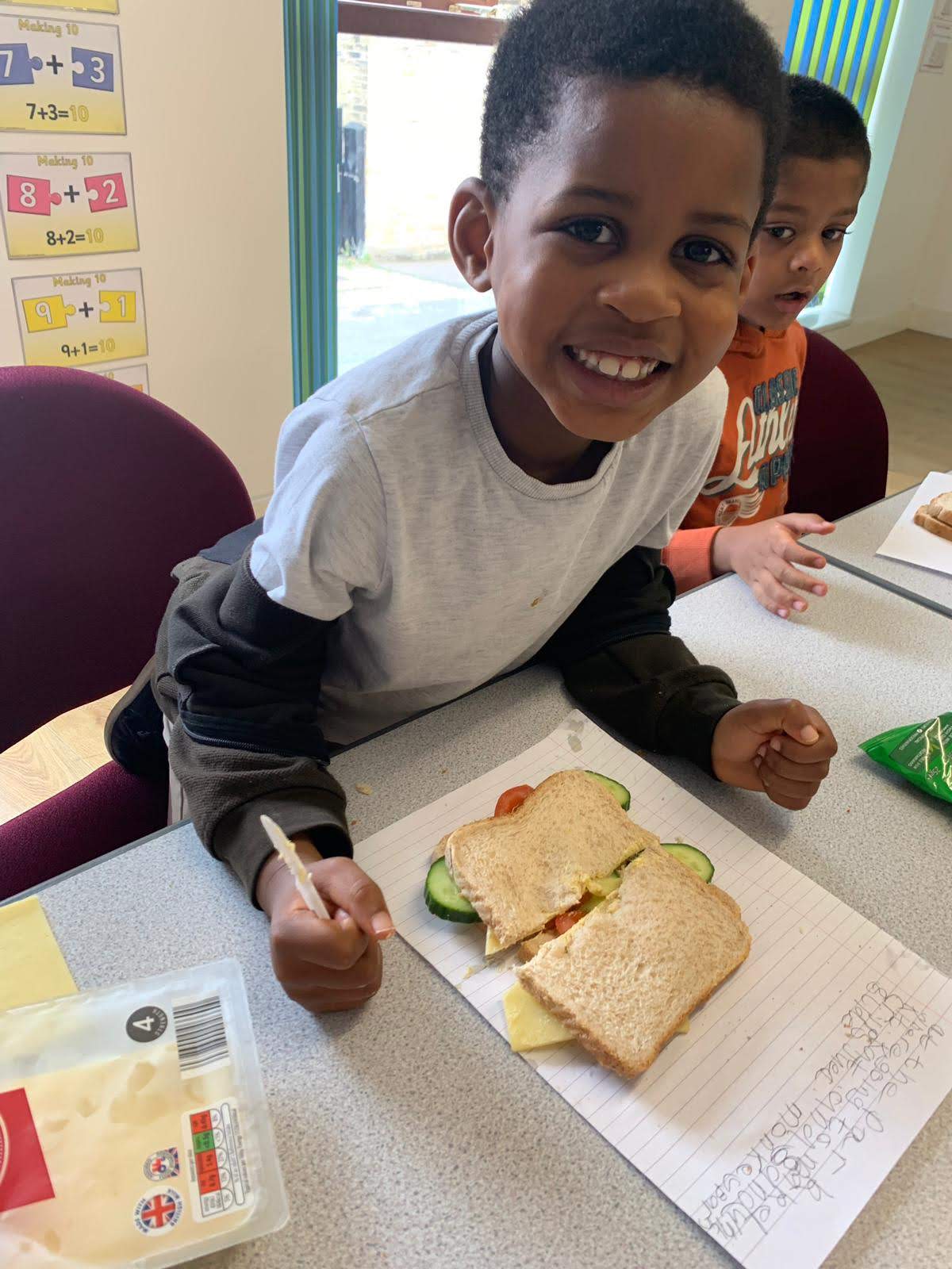 Child making a sandwich at legends care.