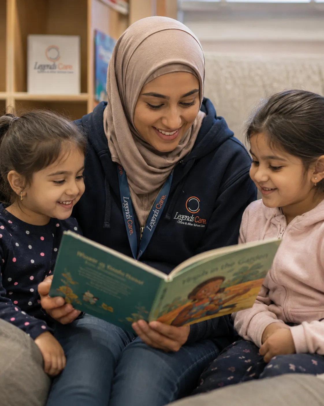 Children enjoying listening to a tutor read them a book