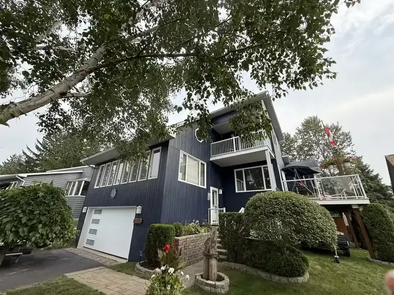 Exterior repaint: Navy siding and white trim by Turtle Painting