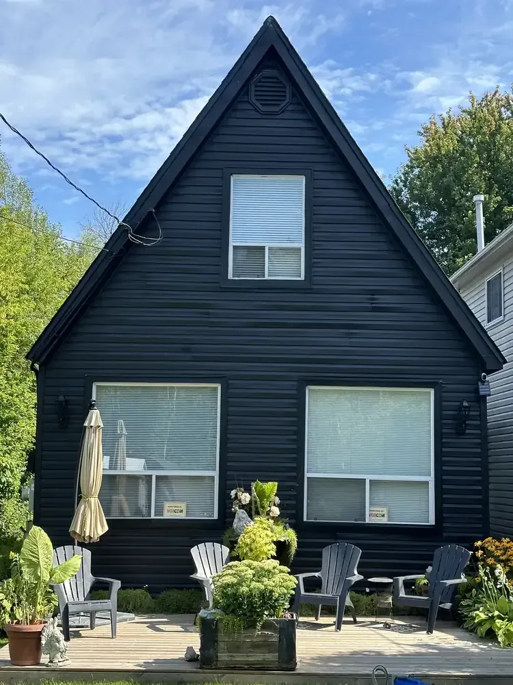 Black A-frame cottage exterior painted by Turtle Painting