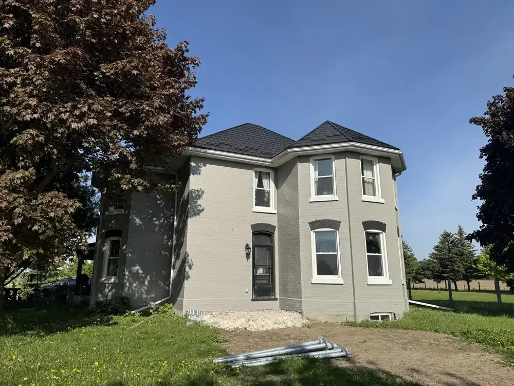 Painted grey brick century home by Turtle Painting