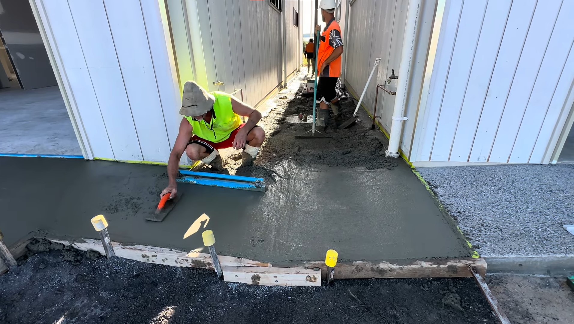 concrete smoothened out by tradies into a pathway between buildings