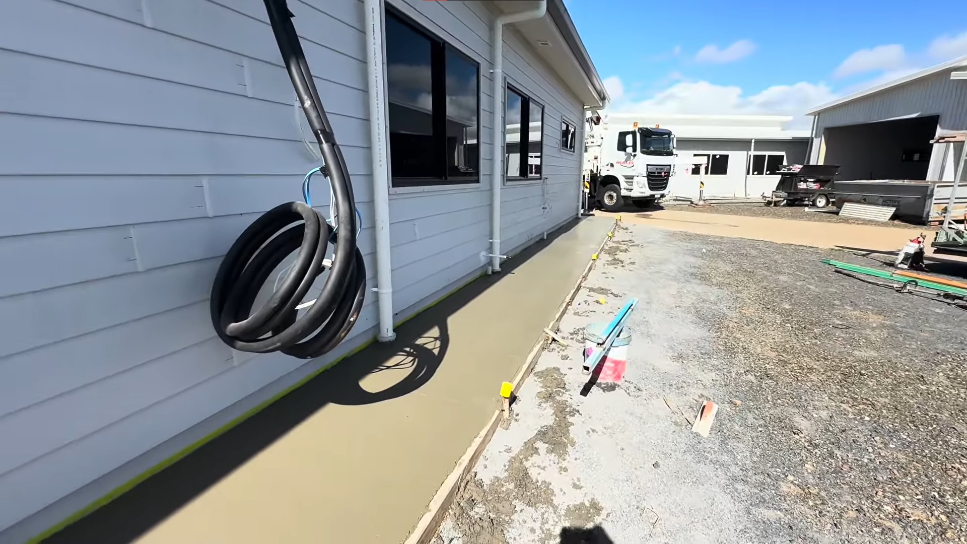 wet smooth concrete on path next to house