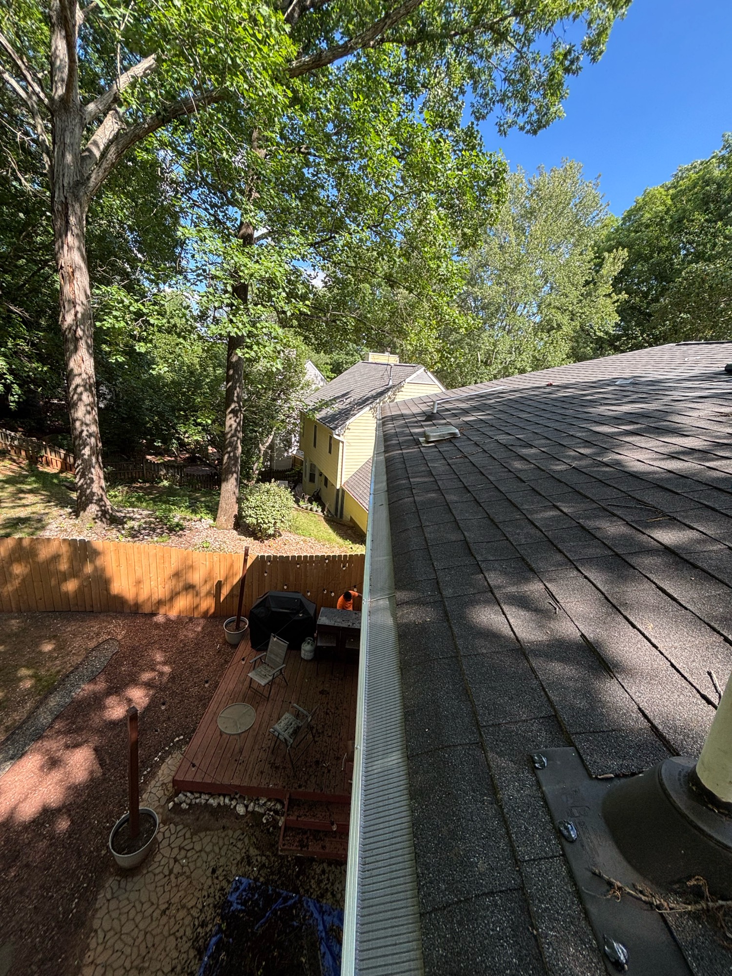 The roof of a building with a tree in the background
