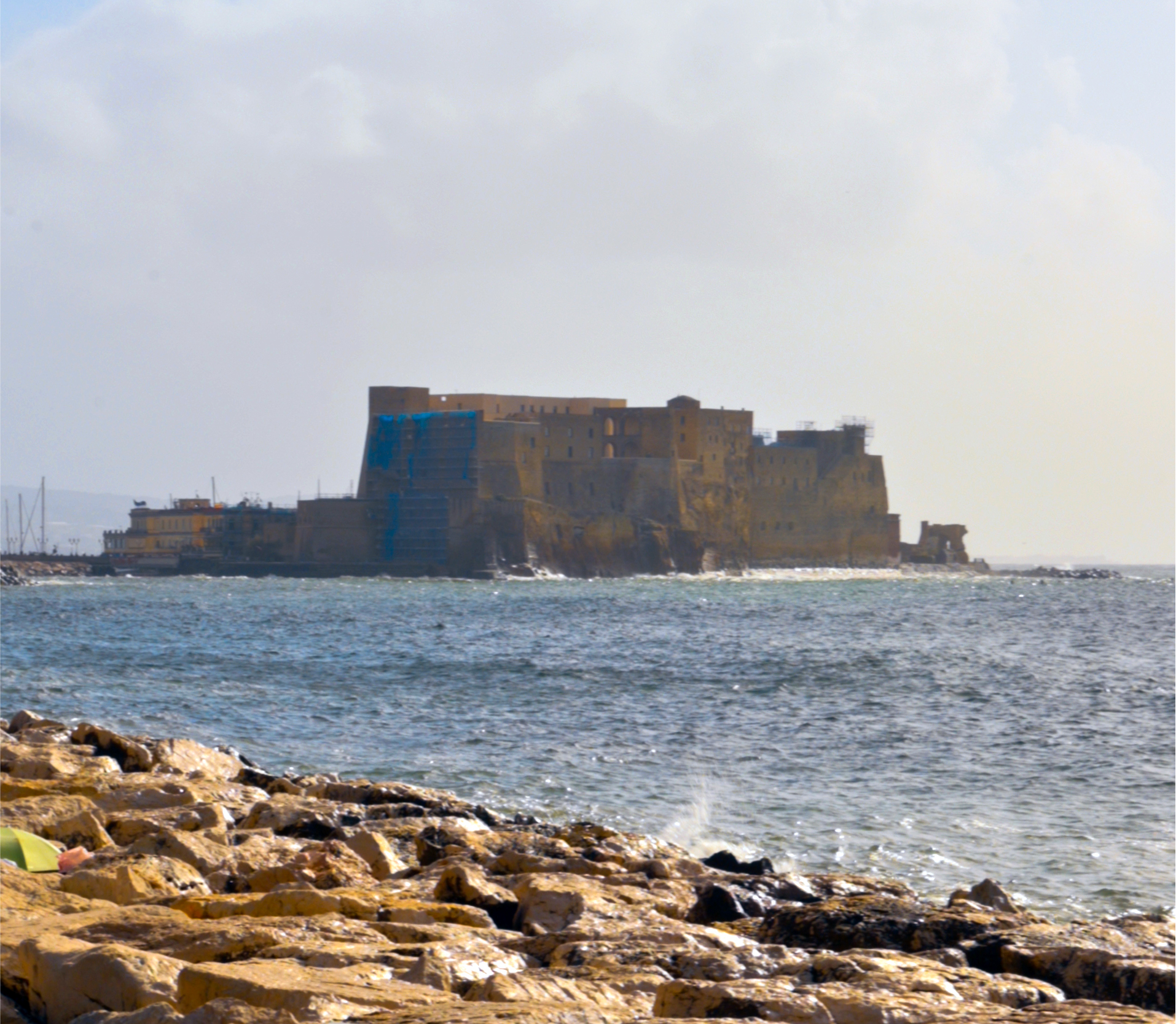 Neapolitan woman smiling on a street in Naples, warm afternoon light.