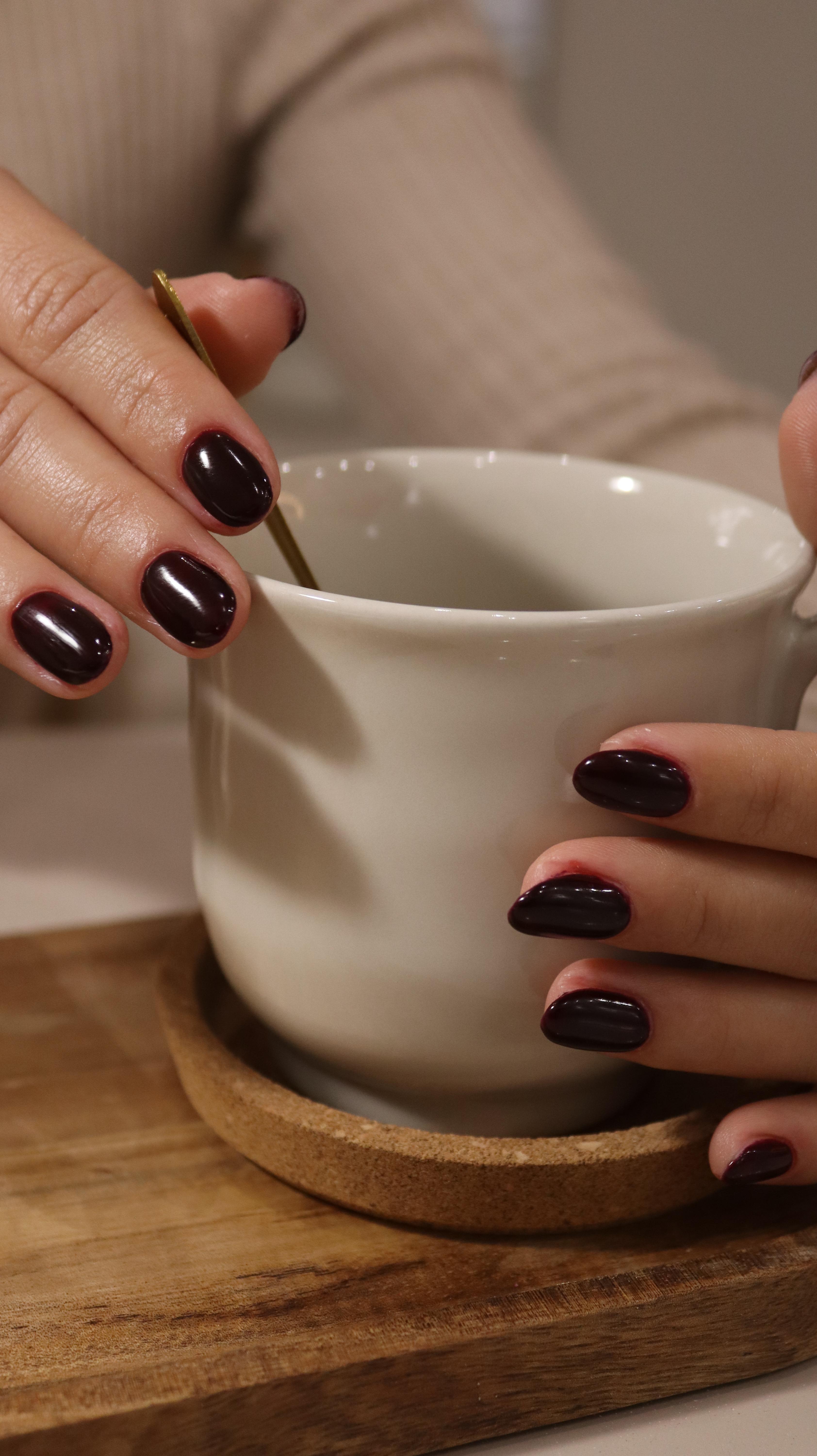 Woman holding skincare product in beauty store