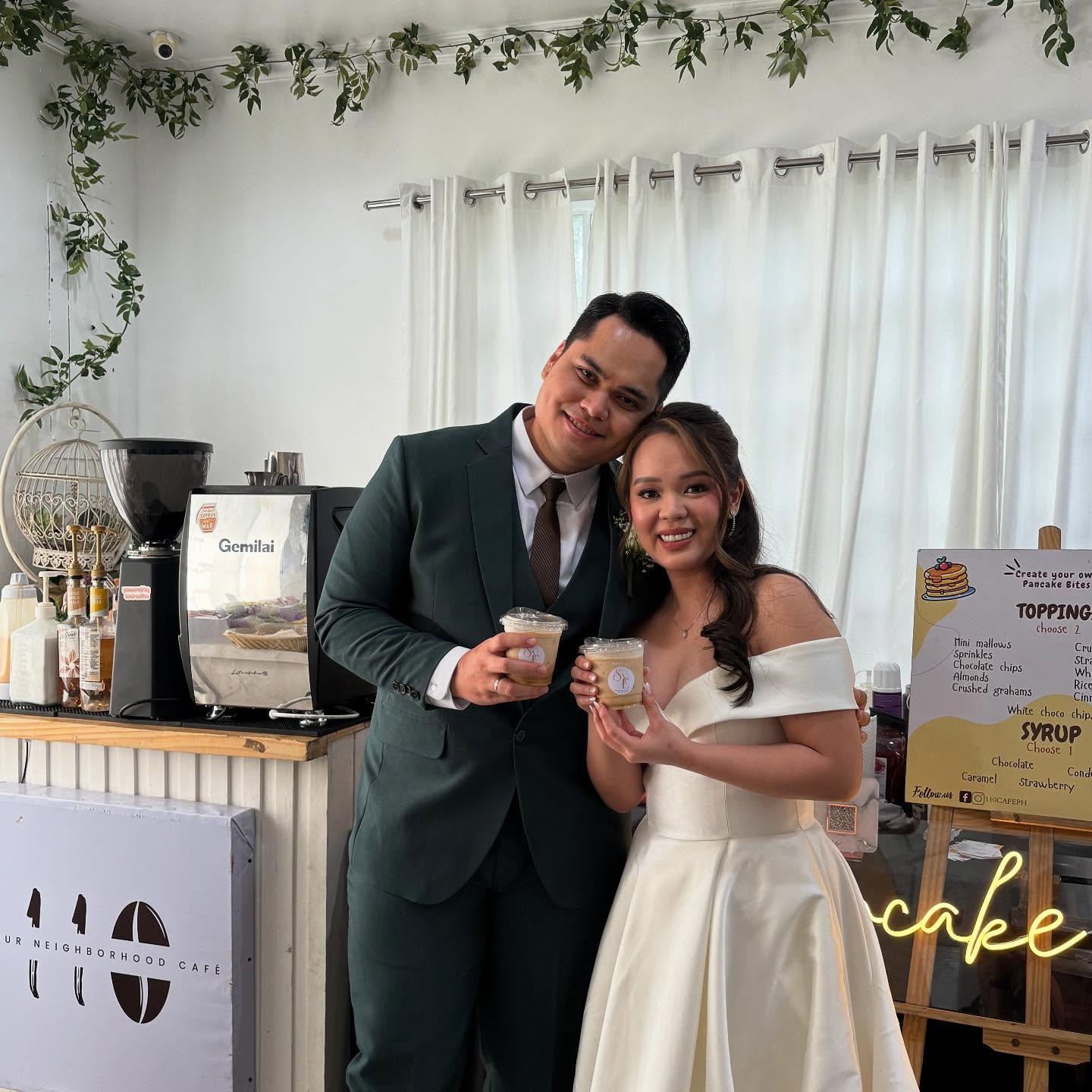 Barista serving handcrafted coffee cups to smiling guests at an elegant wedding reception