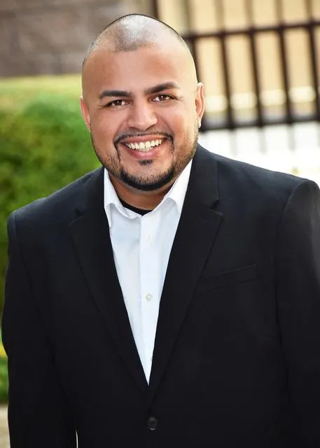 Sunlit portrait of J.R. Lopez in a friendly, welcoming environment