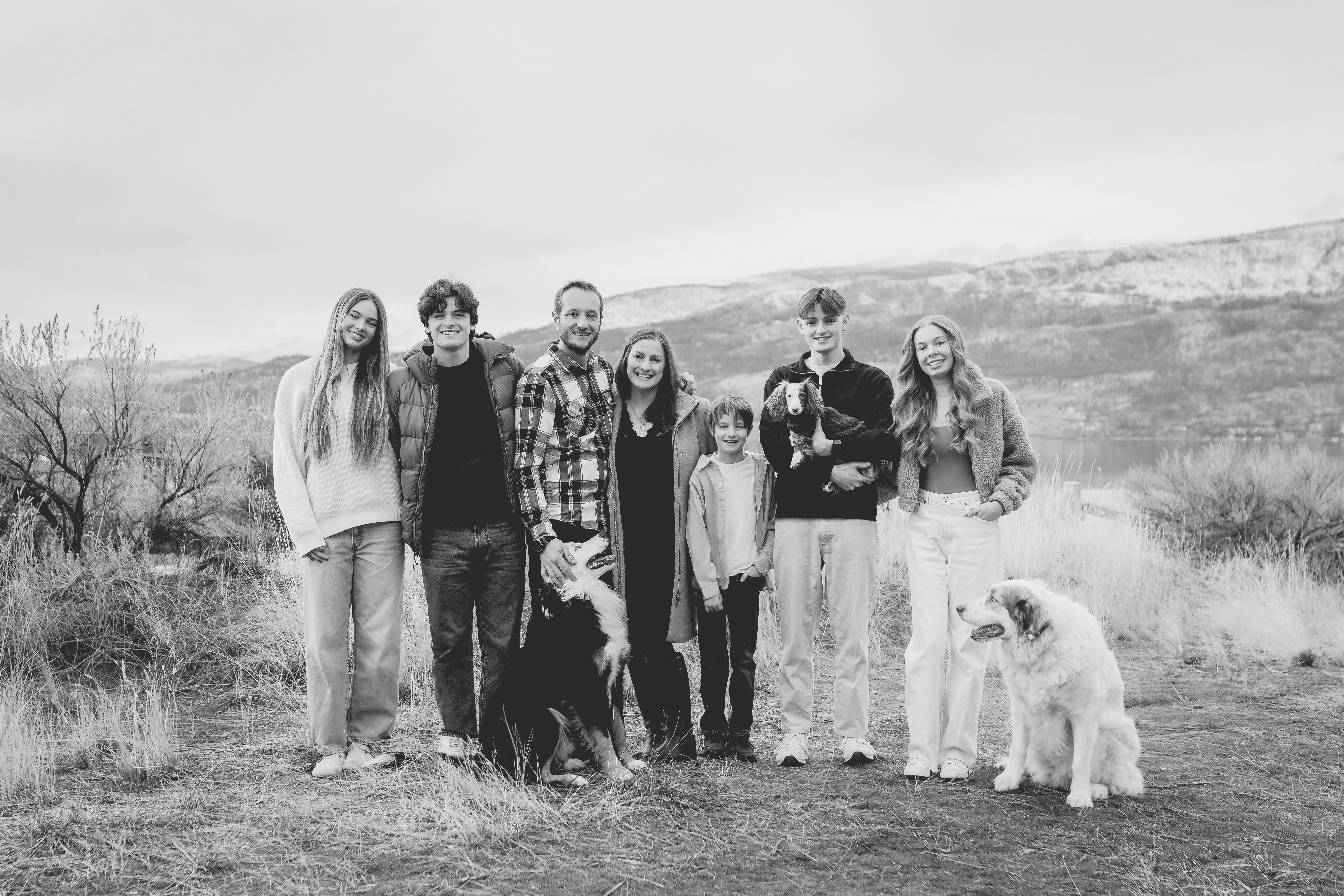The Candid Apple Collective family standing on the ocean
