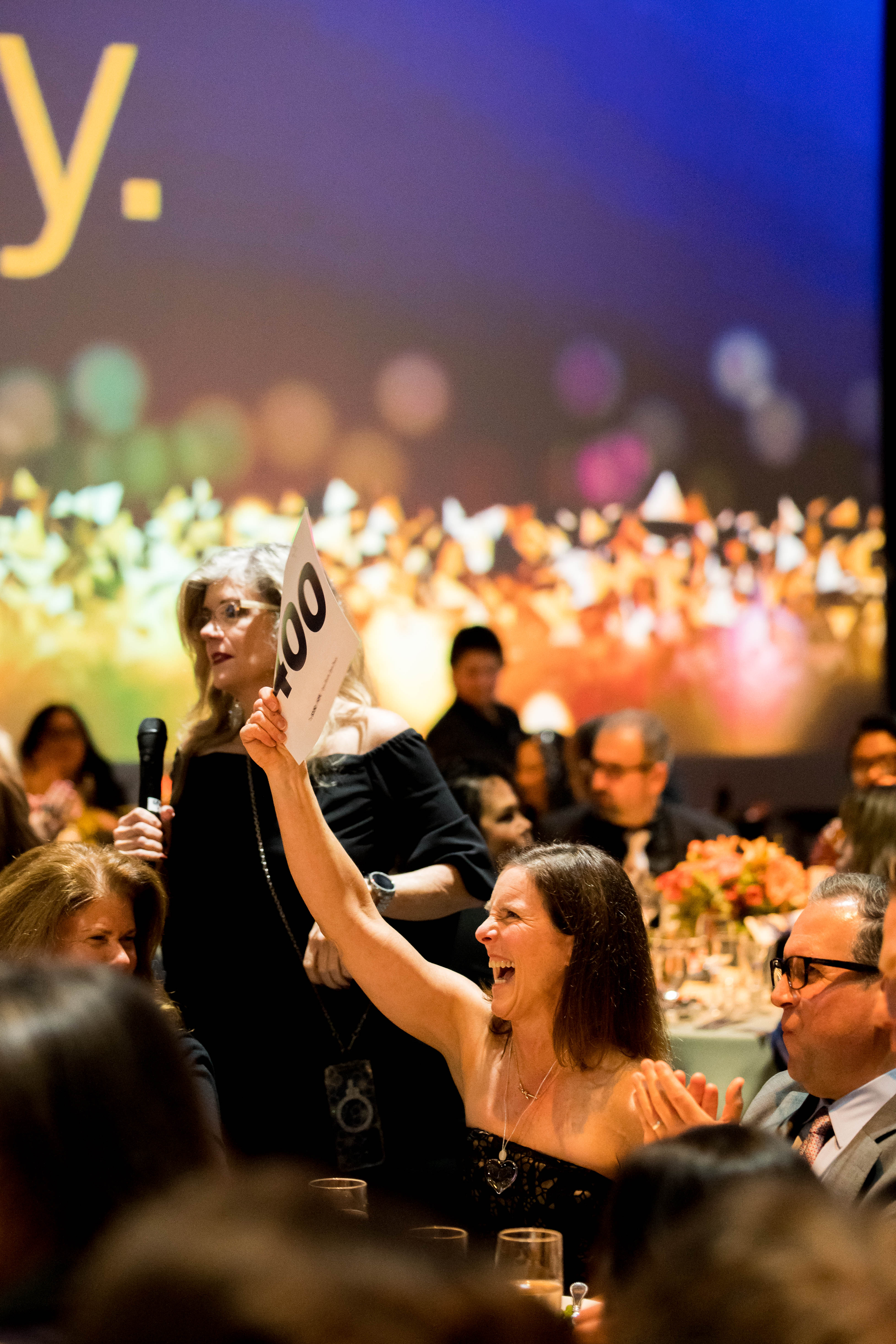 Non-profit leaders shaking hands with E + E event planners in a modern office