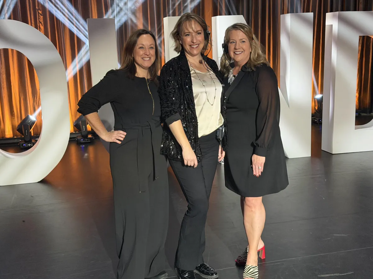 E + E team collaborating in a creative workspace with event materials