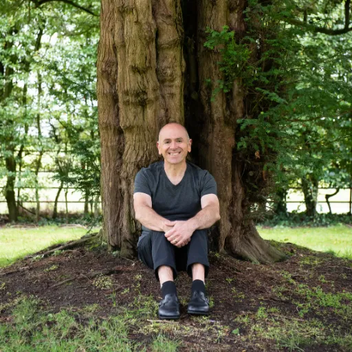 Tony Muratori sitting under a tree