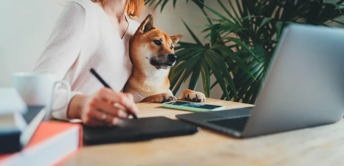 A diverse group of three people, two women and one man, stand together in a bright coworking space, smiling and holding tablets, representing teamwork, achievement, and the positive impact of GHL partnership.