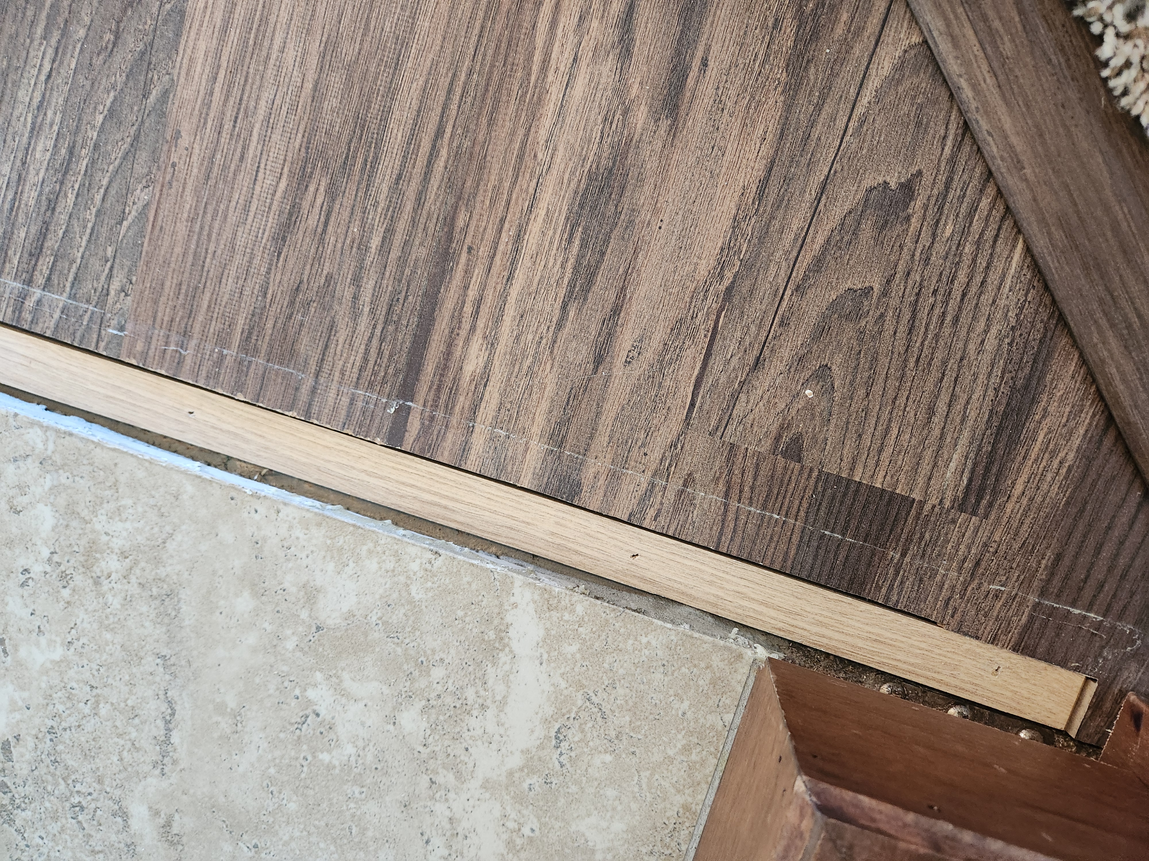 Finished floor transition between wood-look flooring and tile
